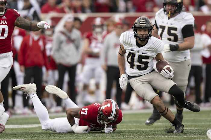 Nov 26, 2022; Bloomington, Indiana, USA; Purdue Boilermakers running back Devin Mockobee (45) evades tackle by Indiana Hoosiers defensive back Jonathan Haynes (17) during the first quarter at Memorial Stadium.